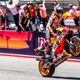 MotoGP race winner doing a wheelie as he crosses the line.